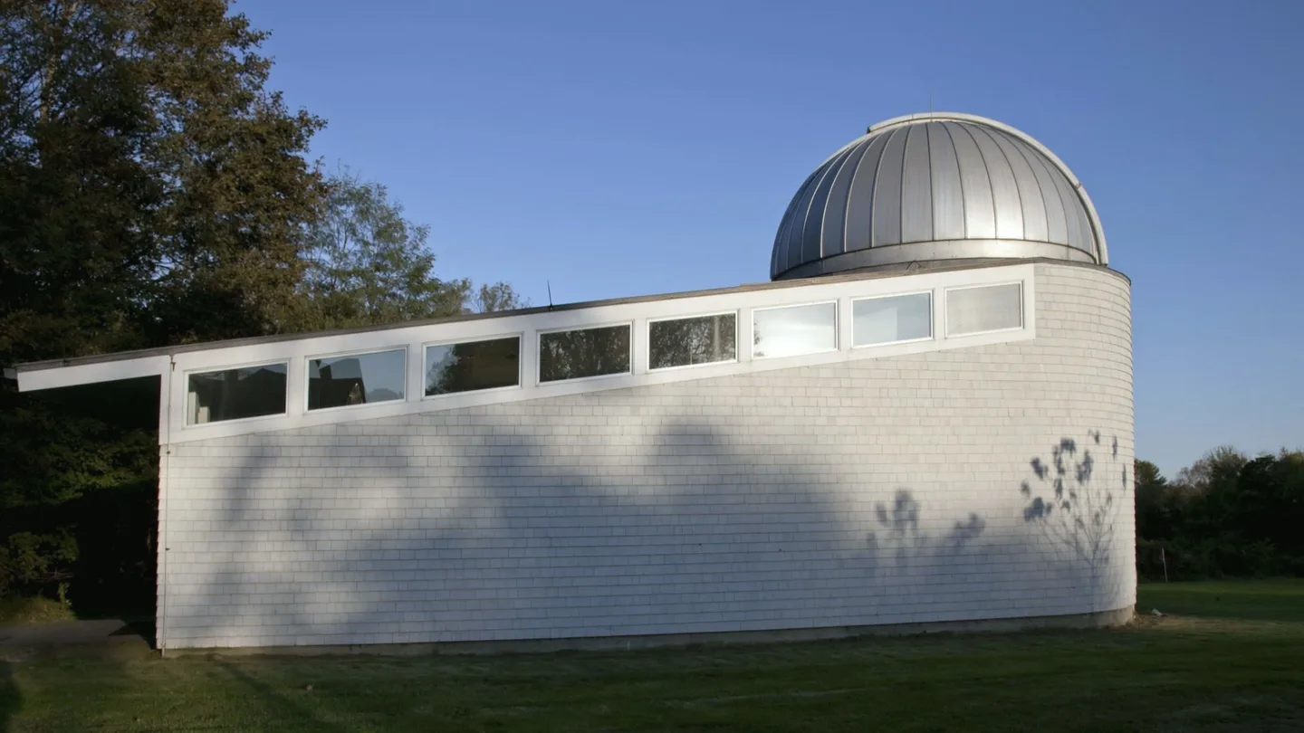 AI-generated atmosphere: the white shingled observatory with its silver dome, animated from a 2011 public-domain photograph.