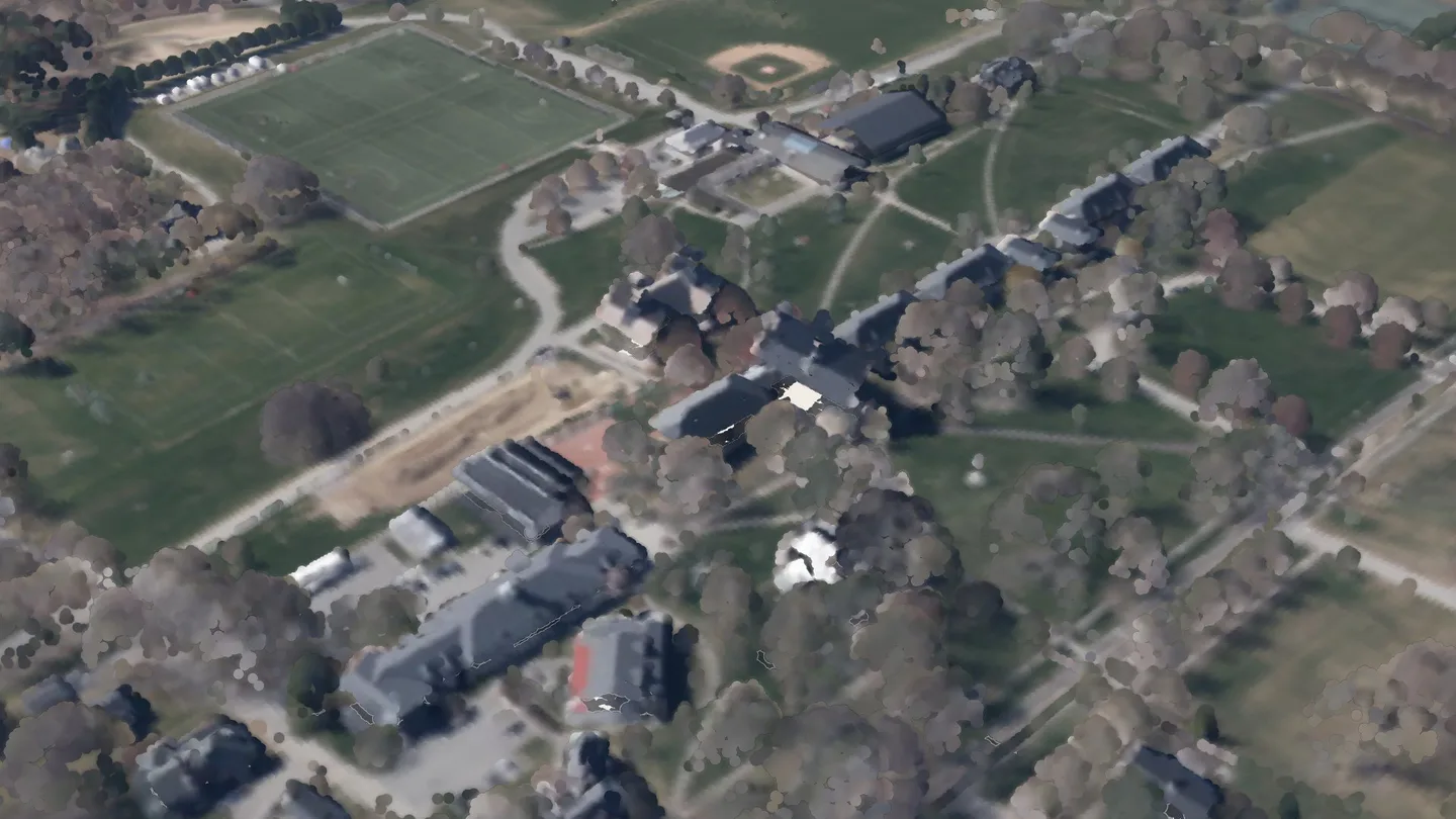 Hard Auditorium among its neighbours, seen from the air to the south-east: a render of the real 2023 LiDAR survey, coloured from the spring 2023 aerial photograph. A crimson ring marks its roof.