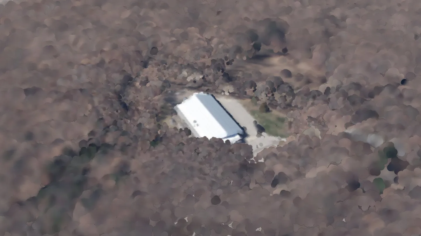 Jahn Rink among its neighbours, seen from the air to the south-east: a render of the real 2023 LiDAR survey, coloured from the spring 2023 aerial photograph. A crimson ring marks its roof.